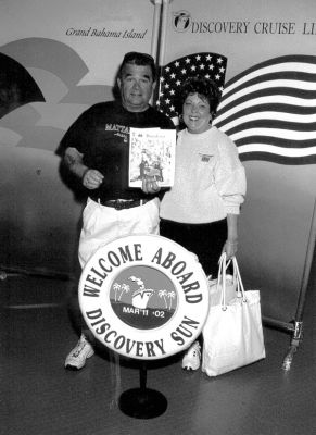 03-21-02
Ken and Melody Pacheco of Mattapoisett recently took a cruise to the Bahamas aboard the Discovery Sun and remembered to bring a copy of The Wanderer along with them, which they posed with here.  (Photo courtesy of Ken Pacheco). 3/21/02 edition
