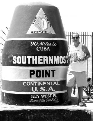 08-08-02
For those of you who have been repeating Its not the heat, its the humidity for the last couple of weeks, just imagine how hot it is right now down in Key West, Florida! Mattapoisett resident Edward Camara Jr. recently submitted this photo of himself posing with a copy of The Wanderer at the Southernmost Point in the Continental U.S.A.  a well-known landmark in Key West which is just 90 miles from Cuba. Aye carumba! (Photo courtesy of Edward Camara Jr.) 8/8/02 edition
