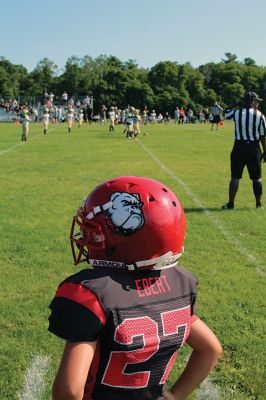 Old Rochester Youth Football 8U 
Old Rochester Youth Football 8U player James Ebert looks over the action during Sunday’s home opener against Dighton-Rehoboth on the ORR High School field. ORYF held three games at the Hagen Stadium on September 4, as the 10U and 12U squads later took the field against teams from New Bedford. Photo by Mick Colageo September 8, 2022 edition
