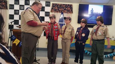 Pack 32
On Saturday, March 23, 27 Cub Scouts from Pack 32 in Marion advanced in rank. Four of them were fifth graders earning the Arrow of Light Award. This is the highest award a Cub Scout can earn, and it is the only Cub Scout badge that can be worn on the Boy Scout uniform. (Left to right) Taylor Young, Benjamin Frazier, Ty McKenzie, and Oakley Campbell. The ceremony was led by Cub Master Kevin Gretton, seen in the photo. The man at the podium was Arrows late leader Michael Young. Photos courtesy Charles Campbel
