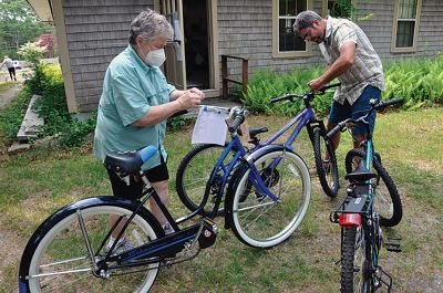 Bikes for All 
Liz DiCarlo and Bill Emmons put the finishing touch, a bell, on two of the 30 bicycles collected by Bikes for All before they are distributed to their new owners on June 19, an effort by the Friends of the Mattapoisett Bicycle and Recreational Path and Mattapoisett Recreation to make sure everyone in Mattapoisett has an opportunity to use the bike path. Photo by Beth David/Fairhaven Neighborhood News
