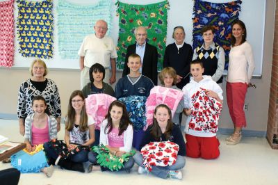 Project Linus
Students from Old Rochester Regional and the Mattapoisett Council on Aging joined together on May 13 to donate their blankets to the Boston-area chapter of Project Linus, an organization that gives blankets to sick and emotionally-distressed children. The children made the blankets, and the volunteers from the COA hand-sewed tags onto each donation. Photo by Anne OBrien-Kakley.
