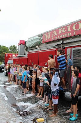 Sippican Elementary Car Wash
Sippican Elementary sixth graders turned Saturday's car wash into a fire engine wash, creating a waterfall of suds and having the kind of fun kids normally associate with what happens on the weekends before school is back in session. Organized by Volunteers at Sippican Elementary (VASE), the school's 501(c)(3) non-profit parent-teacher organization, the event held at the Marion school's bus loop off Main Street raised money for the students' mountain classroom trip, a three-day excursion planned for June 20
