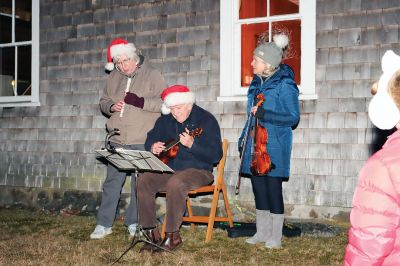 Tinkhamtown Chapel Christmas Carol Singalong
Sunday's participants in the Tinkhamtown Chapel Christmas Carol Singalong braved a dramatic, postsunset drop in temperature and enjoyed the warmth of a solo bonfire loaned to the event by Lee Heald. Gail Roberts led distributed sheet music and led in song with musicians Louise Anthony playing the fiddle and Jack Dean the ukulele. Roberts thanked the White family for providing refreshments, the Chapel committee for its effort in maintaining the chapel 
