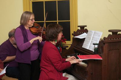 Tinkhamtown Chapel 
Gail Roberts of Mattapoisett (right) invited her friend from Canada, fiddler Elizabeth Corewin (left) to accompany the audience for the annual Tinkhamtown Chapel sing on Saturday, December 22.  Photo by Eric Tripoli.
