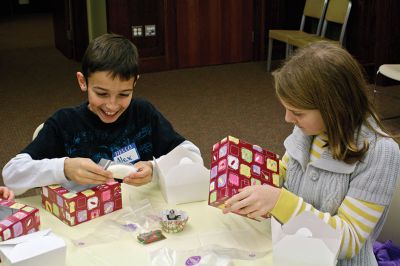 Cupcake Decorating
Alex Wurl (left) and Elsie Perry explore the different parts of their decorating kits at a holiday cupcake actvitiy offered by the Mattapoisett Free Public Library on Wednesday, December 5.  Photo by Eric Tripoli.
