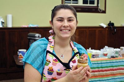 Cupcake Decorating
ORR senior Mattie Boyle poses with the cupcake she decorated while helping out local kids create theirs at the Mattapoisett Free Public Library on Wednesday, December 5.  Boyle has a passion for baking and was recently accepted to the culinary school of Johnson & Wales, in Charlotte, N.C.  Photo by Eric Tripoli.
