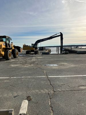 Harbor Dredging 
Mattapoisett’s Highway Department has been busy dredging soils that have built up between the wharves, impeding the use of dinghies at low tide. Photos by Marilou Newell

