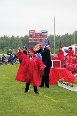 Tri-Town Graduation
Aveil Ward responds to a thunderous cheer upon receiving his diploma during Old Rochester Regional High School’s graduation exercises on Saturday at the David S. Hagen Memorial Field in Mattapoisett. At right is Superintendent of Schools Mike Nelson and in the background, ORR Vice-Principal Vanessa Harvey. Photo by Mick Colageo
