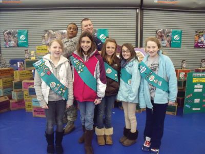Cookies for a Cause
Junior Girl Scout Troop #81154 from Marion participated in Cookies for a Cause at Hanscom Air Force Base on March 5, 2011. Thousands of boxes of donated cookies will be sent to service men and women overseas. From left to right, Sadie, Sienna, Sophie, Sydney and Caitlyn are pictured with two servicemen from Hanscom Airforce Base. Photo by Tina Sa-Weedall.
