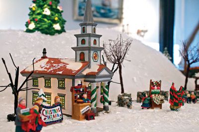 Holiday Tour
The Mattapoisett Historical Society and Carriage House opened its doors for the holiday season on Saturday, November 24.  The Historical Society is having its annual holiday shop, which features a variety of unique gifts such as historical postcard and map recreations, books, and tree ornaments.  Kids will get a kick out of the Lionel model train that zooms past a village of illuminated porcelain buildings. Photos by Eric Tripoli.  November 29, 2012 edition
