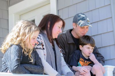 Habitat for Humanity Home
Christine and Josh Liggerio stand with their daughter Hailey, 9, and son Keagan, 6, on the porch of their new Habitat for Humanity home in Marion on March 19. The Liggerios celebrated the completion of their new Wareham Road home with Habitat for Humanity of Buzzard’s Bay executives, Representative Bill Straus, and a crowd of well-wishers during a dedication ceremony on Saturday. Photo by Felix Perez
