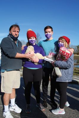 With her December 13 run from Island Wharf down to Silvershell Beach, Hannah Strom took a significant step in her long road to recovery from injuries sustained almost a year ago in a crash with the Holy Cross rowing team. At the end of her run, her father Tom surprised her with a puppy named Ruthie. Photo by Mick Colageo
