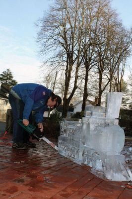 Ice Sculpture at the Marion Art Center
In front of the Marion Art Center, Tim Wade carved out an ice sculpture of a train on December 13, an unseasonably warm December day. The MAC reported several phone calls concerning the heat and whether the event would be canceled. Wade made his icy creation despite the warmth, as he has done for 10 years. Photos by Jean Perry
