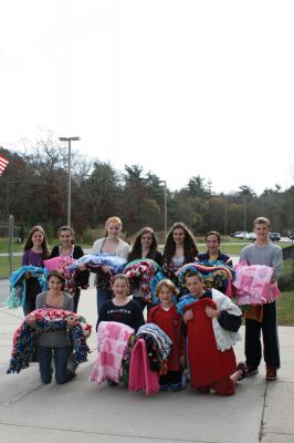 Share the Warmth
Fifteen students from Jane Tougas' eighth grade Enrichment Class display the 50 blankets they helped make for Project Linus, a charity that provides handmade blankets to seriously ill and traumatized children. Front row, left to right: Olivia Lanagan, Lizzie Machado, Seth Richard, and Chris Demers. Back row, left to right: Renae Reints, Tori Saltmarsh, Katie Zartman, Kelly Kay, Ali Grace, Nicholas Bergstein, and Andrew Dessert. Photo by Anne O'Brien-Kakley. November 26, 2009 edition
