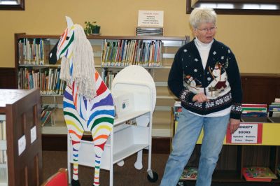 Reading Time
Mattaposiett Free Public Library Childrens Librarian Linda Burke shows off Zebro, a library cart that collects books and keeps the childrens room neat and organized. Ms. Burke gave a special storytime to preschoolers on Friday, January 8, 2010. Photo by Anne OBrien-Kakley.
