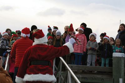Marion Holiday Stroll 
Here Comes Santa Claus! – Santa made his big entrance to the Marion Holiday Stroll on Sunday, December 8, from across Sippican Harbor on his ‘water sleigh’ to the crowd that awaited him at the Town Wharf. The holiday stroll is the perfect way to get into the holiday spirit and capture a bit of that Christmas magic. Photo by Jean Perry
