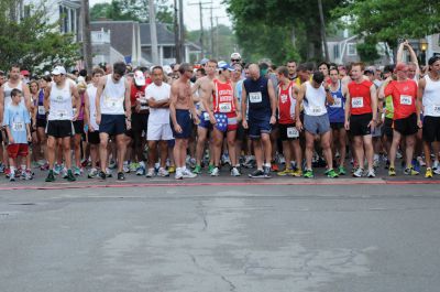 Mattapoisett Road Race
On Wednesday, July 4, over 1,000 runners braved the rain to participate in the Annual Mattapoisett Road Race.  All money raised from the 5-mile race will benefit graduating students from Old Rochester Regional High School.  Photo by Felix Perez.
