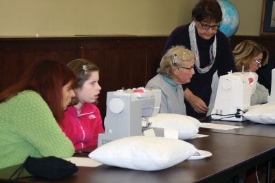 Learning Sewing
Mary Chaplain and Bobbi Gaspar led a group of eager participates as they learned the basics of sewing machine operation on March 18 at the Mattapoisett Public Library. The 11 ladies and one young, but experienced novice Brenna Carrier, 12, created covered pillows during the exercise. Library staffer Robbin Smith said that due to popular demand, a second session is planned for May. Photos by Marilou Newell
