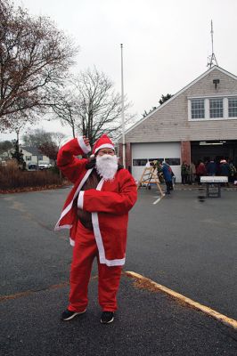 Mattapoisett Woman’s Club
Sandra Hering is decked out in Santa attire as she invites traffic to turn into Saturday morning’s sale of wreaths and other assorted Christmas decorations at the Fire Station on the corner of Route 6 and Barstow in Mattapoisett. The annual event, put on by the Mattapoisett Woman’s Club, raises money to fund a college scholarship. Photos by Mick Colageo
