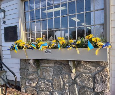 At the Mattapoisett Woman’s Club luncheon on March 17, members donated to support World Central Kitchen for Ukraine and filled a jar with cash and checks totaling $500. The next afternoon, March 18, several members of the Garden Group collaborated to create window-box displays at the Mattapoisett Post Office. The design was created by Sharon Doyon to show support for the people of Ukraine. The Garden Group was honored to have several people stop to comment and thank them for their efforts
