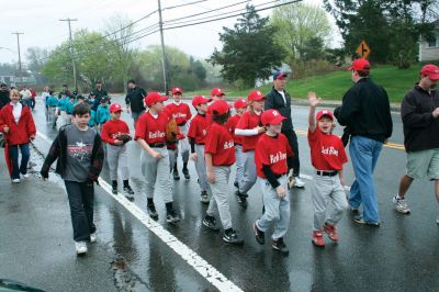 Opening Day
The Mattapoisett Youth Baseball League opened their 2009 season with a parade down Route Six on Saturday morning, May 2. Special guest and Boston Red Sox mascot Wally the Green Monster was on hand to throw out the first pitch and sign autographs for the young players. Photo by Robert Chiarito.
