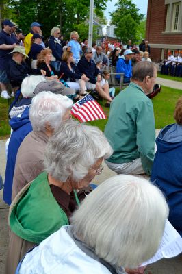 Memorial Day 2014
Scores of Mattapoisett residents gathered in front of the Mattapoisett Free Library the drizzly afternoon of May 26 to pay homage to veteran Americans who lost their lives. Onlookers filled the lawn and spilled out into the street to watch the Memorial Day ceremony with special guest speaker Navy Reserve Commander Paul J. Brawley who served more than 22 years of active duty and reserve service. After the ceremony, participants paraded through the town to the town wharf. Photo By Jean Perry
