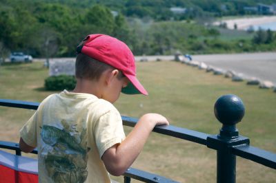 Lighthouse Tours
Nathan Winterhalter of Florida peers over the railing at the top of Ned's Point Lighthouse in Mattapoisett during a tour on Thursday, July 12, 2012.  Photo by Eric Tripoli.
