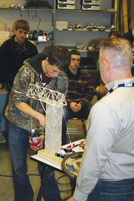 Principles of Engineering
ORRHS teacher Tom Norris’ Principles of Engineering class tested on March 29 to see if the robotic balsa wood cranes students designed could lift at least two pounds. Six groups of 2-3 students designed their own cranes, motors, and pulley systems using only a set limited supply of materials. Pictured left: Davis Mathieu (left) adds more weights while Norris (right) observes. Photos by Jean Perry
