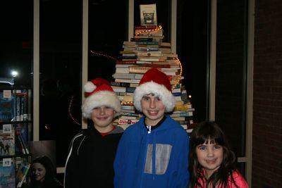 Library Open House
Steven Carvalho, left, Matthew Carvalho, center, and Julia Carvalho, right take time out to smile in front of the Book Christmas Tree at the Mattapoisett Library.  On Tuesday, December 11, the library hosted their Annual Holiday Open House.  Photo by Katy Fitzpatrick.
