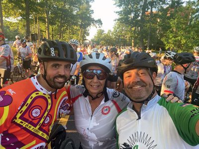 anMass Challenge
Rochester Memorial School teacher Debbi Bacchiocchi has become a regular rider of the PanMass Challenge, joining other Tri-Town community members in the mission to cure cancer. Here, she is pictured with Old Rochester Regional High School Athletic Director Bill Tilden and also with fellow Rochester residents Lazaro Rosa and Keith Riquinha at the start of the race on Day One. Bacchiocchi victoriously celebrated reaching Provincetown on Day Two and offered a look at the back of her racing shirt. Photos courte
