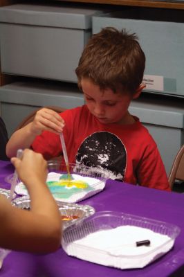 Science Roadshow
The Children’s Museum in Easton brought its Science Roadshow to the Plumb Library on August 6, and showed kids how to make a rocket out of a film canister (remember those?) and an Alka-Seltzer, and create sizzling artwork with vinegar, food coloring, and baking soda. Photos by Jean Perry
