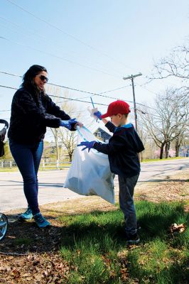Rochester Women’s Club Earth Day Cleanup 
Gavin Riquinha, a six-year-old Kindergarten student at Rochester Memorial School, delivers to his mother Stacey some trash he picked up in the brush near the corner of Marion and Dexter roads during Saturday’s Rochester Women’s Club Earth Day Cleanup event. Families and friends were out and about, along with members of Boy Scout Troop 31, pulling all sorts of unpleasant surprises from the roadside. Looking on from the carriage is Gavin’s three-year-old brother Noah. Photo by Mick Colageo
