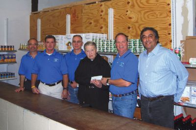 Rochester Road Race
Officials of the Rochester Road Race formally offer a donation to Damien's Pantry, the beneficiary of the annual race that took place last August. Photo courtesy of Chuck Kantner
