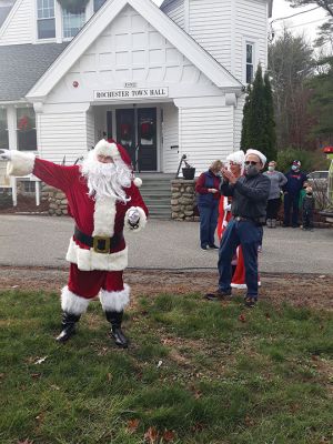 Santa Arrives
The Town of Rochester wasn’t able to host its traditional Christmas celebration this year, but the Fire Department made sure that Santa and Mrs. Claus and Sparky visited with children on Sunday outside Town Hall, where Board of Selectmen Chairman Paul Ciaburri presided over the lighting of the tree. Ciaburri was thrilled to report that the Christmas Angels, run by Lorraine Thompson with volunteers from the Council on Aging, the public library, local businesses, schools, and churches haven’t missed a beat.
