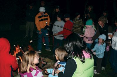 Moonlit Salty
Everyone had a blast at Saltys Moonlight Soiree at Dunseith Gardens on November 7, 2009. The Mattapoisett Land Trust provided sticks, marshmallows, chocolate, graham crackers, and entertainment. Children roasted their marshmallows while they enjoyed Big Ryan from Big Ryans Tall Tales. Photo by Anne OBrien-Kakley.
