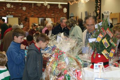 Christmas Holiday Shop
St. Anthonys and St. Ritas parishioners combined efforts to give the community a Christmas Holiday Shop and Celebration on Saturday, December 5, 2009. The basement of St. Anthonys church was decked out in snowflakes, wreaths, bells, bows, and a Santa sleigh. Santa listened patiently as children told him what they wanted for Christmas. A beautiful bake table tempted visitors with gooey confections and warm malasadas were enjoyed by all. Photo by Anne OBrien-Kakley.
