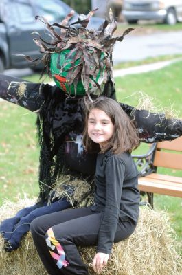 Scarecrow Fun
Alexandra Macallister takes a break and poses with her scarecrow at the October 15, 2011 Mattapoisett library scarecrow contest. Photo by Felix Perez.
