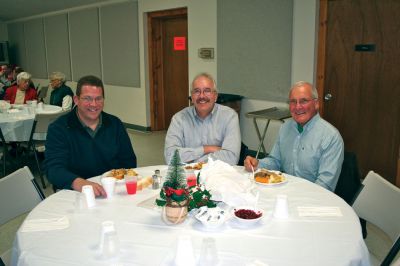 Senior Holiday 
The Marion Police Brotherhood hosted a holiday dinner for seniors at the Marion Social Club on Saturday, December 17. From left to right: Marion Police Chief Lincoln Miller and Selectmen Stephen Cushing and Roger Blanchette enjoy some good conversation over a meal. Photo by Robert Chiarito.
