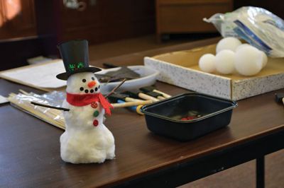 Build-your-own Snowman
Under the direction of Jeanne McCullough, children at the Mattapoisett Free Library on December 30 participated in a step-by-step build-your-own snowperson activity during the winter school break. Little fingers sticky with glue flattened out cotton balls and fastened them to prefabricated Styrofoam snowperson shapes, and then glued on the trimmings under the guidance of caregivers. Photos by Jean Perry
