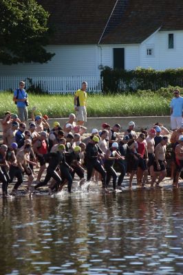 2011 Triathlon
240 athletes kicked off the Harbor Days week on July 10, 2011 with the Mattapoisett Lions Triathlon, which started from Mattapoisett Town Beach and included a .25-mile swim, a 10-mile bike ride and a 3-mile run. The mens winner for the Triathlon was Keith Putnam or Marston Mills, MA with a time of 52:52, and the womens winner was Katie McCully of Eastham, MA with a time of 58:51. Photo by Anne Kakley.
