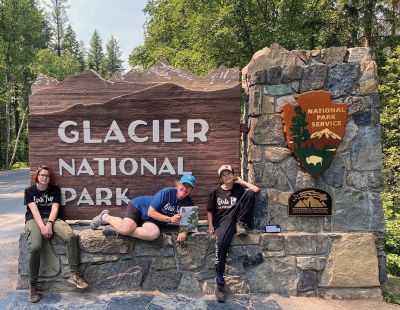 Glacier National Park in Montana
Now that folks are getting out and about again, don’t forget about our Wandering Wanderer pictures. Bring a copy of The Wanderer with you and send us a photo to share with our readers. Pictured here: Walker, Ellen Scholter, and Emma Kendrigan with The Wanderer at the west entrance to Glacier National Park in Montana.
