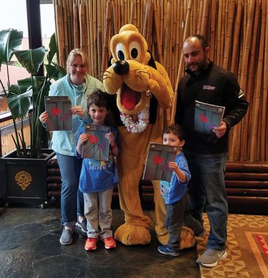 Polynesian Village Resort
The Maloof Family at the Polynesian Village Resort in Disney World. Holly Maloof, a reading specialist at Center School, Timmy, a first-grader at Center School with Pluto, Timmy’s little brother Joey, and father Patrick enjoyed a week away from the cold. Timmy made sure everyone brought along a copy of The Wanderer.
