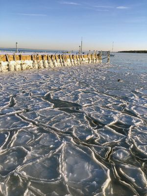 Ice, Ice, Baby
Buzzards Bay was frozen over on Sunday afternoon after many days of brutal cold and then sub-zero temperatures Sunday morning. The frozen scene from Mattapoisett Wharf shows a desolate, arctic landscape marked with random patterns and designs on the icy surface of Buzzards Bay. Photo by Scott Anderson
