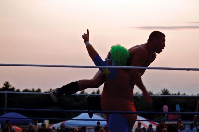 Rochester Wrestling
Doink the Clown milks the audience for applause while spinning his opponent in the air.  Doink was a popular wrestling character in the early to mid 1990s, with several different men performing under the moniker.  Photo by Eric Tripoli.
