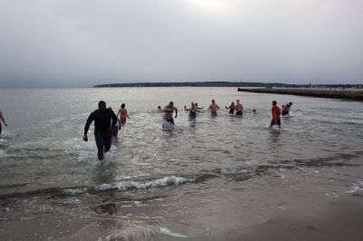 Christmas Plunge
An ice-cold Christmas morning in Mattapoisett did not stop citizens from jumping all the way into the waters of Mattapoisett Town Beach in support of Helping Hands and Hooves. Photos by Mick Colageo
