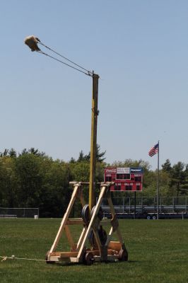 Trebuchet Time
Senior Carl Dias and freshman Callum McLaughlin from Old Rochester Regional High Schools engineering class constructed this large working trebuchet with guidance from their teacher Tom Norris. The trebuchet was tested in the football fields with gallons of water, a rock and a watermelon. Delightful throwing and smashing ensued. Photo by Anne OBrien-Kakley.
