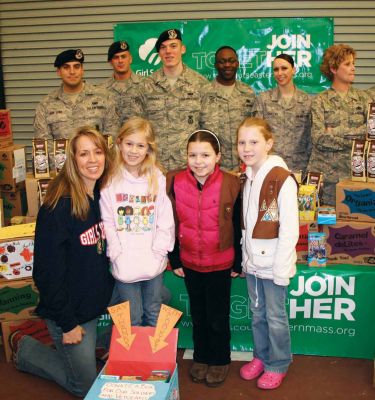 Scouts' Honor
L to R: Stacey Soucy (leader), Delaney Soucy (2nd gr), Emily Humphrey (2nd gr. ), Sadie Weedall (3rd gr.) pictured with troops from Hanscom Air Force Base at a recent ceremony where their Girl Scout Troop donated cookies for the soldiers serving over seas. March 5, 2009 Edition
