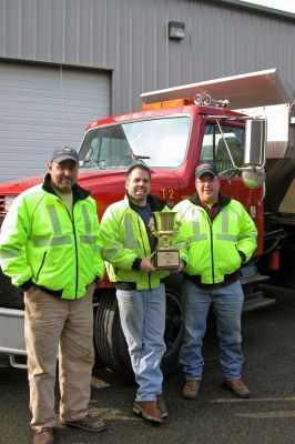 Rodeo Champs
(L. to R.) Rochester Highway Department members Bob Lake, Highway Surveyor Jeff Eldridge, and Bob Laferriere pose with the trophy they received for taking First Place in the recent New England Chapter of the American Public Works Associations (APWA) Regional Snow Plow Rodeo held in Manchester, NH. Rochesters Highway Department has won multiple awards in past competitions, but this marks the first time they have taken top honors in both the state and regional events in the same year. (Photo by Kenneth J. Souza).
