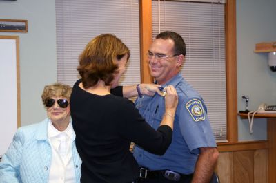 Police Promotion
Mattapoisett Police Officer Anthony Days is pinned with his new sergeant's badge by his girlfriend, Meredith, while his proud mother Hilda looks on. Officer Days was recently promoted to the rank of sergeant with the Mattapoisett Police Department during the Mattapoisett Selectmen's meeting. (Photo by Kenneth J. Souza).

